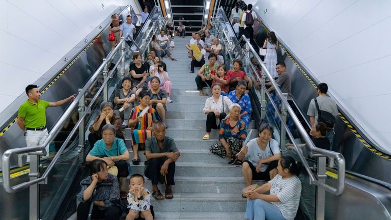 People in China turned to air conditioned underground stations to try to keep cool amid prolonged 40C heat this summer. Pic: AP