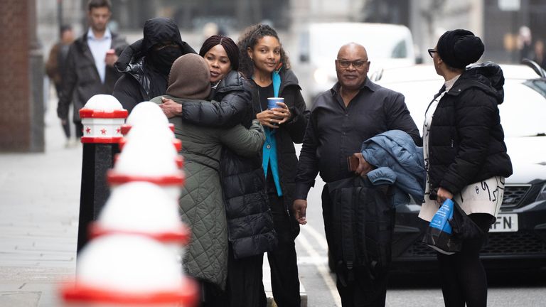 Helen Lumuanganu the mother of Chris Kaba hugs friends alongside Prosper Kaba (second from right) the father of Chris Kaba outside the Old Bailey, central London, where Metropolitan Police firearms officer Martyn Blake is charged with the murder of Chris in south London on September 6 2022. Mr Kaba died after being shot once in the head through the windscreen of an Audi car in Kirstall Gardens, Streatham. Picture date: Tuesday October 15, 2024.