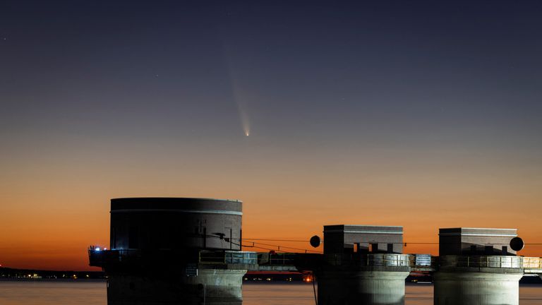 Comet C/2023 A3 (Tsuchinshan-ATLAS) is visible shortly after sunset in the western sky over the Lake Murray Dam Hydroelectric Intake Towers near Columbia, South Carolina, U.S. October 12, 2024. REUTERS/Sam Wolfe