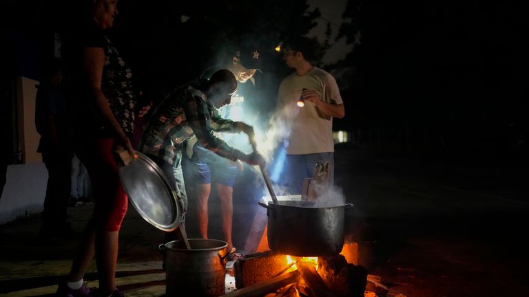 People cook soup over an open fire this weekend in Havana, amid the blackouts. Pic: AP