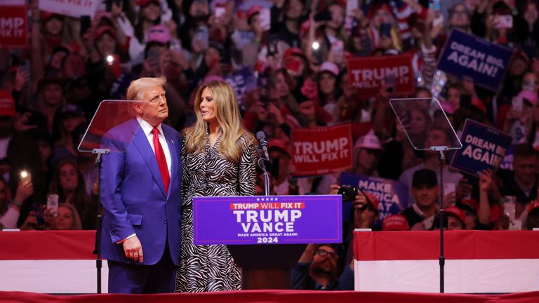 Republican presidential candidate and former U.S. President Donald Trump hugs Melania Trump during a rally at Madison Square Garden in New York, U.S., October 27, 2024. REUTERS/Andrew Kelly