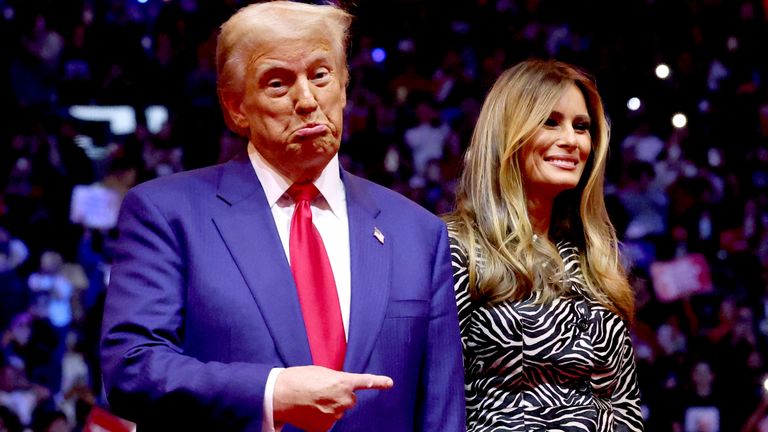 Donald Trump points his finger next to Melania Trump during a campaign rally at Madison Square Garden.
Pic: Reuters