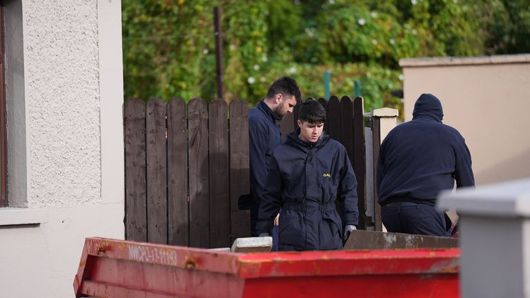 Members of a Gardai search team during a search of vacant land behind a house in Dundalk. Photo: PA