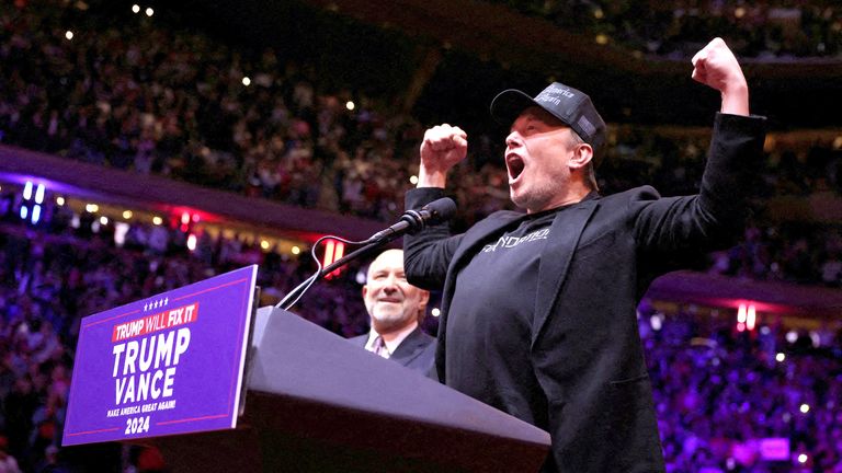 Elon Musk gestures on stage next to Howard Lutnick, Chairman and CEO of Cantor Fitzgerald during a rally for Donald Trump at Madison Square Garden.
Pic: Reuters