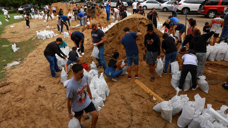 People prepare sandbags ahead of the arrival of Hurricane Milton, in Orlando, Florida, U.S. October 8, 2024. REUTERS/Jose Luis Gonzalez