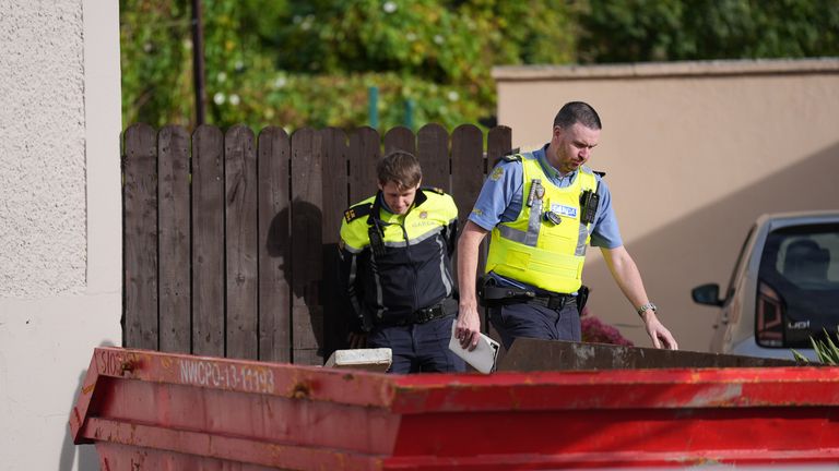 Gardai during a search of vacant land behind a house in Dundalk. Photo: PA