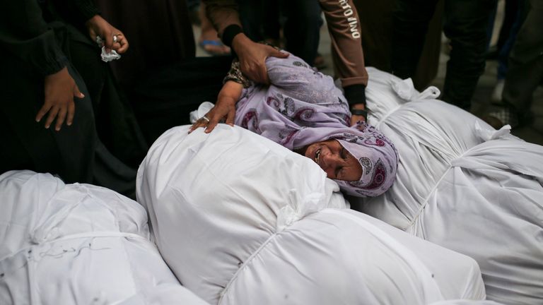 FILE - Palestinians mourn over the bodies of relatives killed in an Israeli airstrike, outside the morgue in Al-Aqsa Martyrs Hospital in Deir al Balah, the Gaza Strip, on June 10, 2024. A proposed cease-fire deal between Israel and Hamas is the latest serious attempt to wind down the war, and while it still faces significant hurdles, negotiations meant to bring it to fruition are ongoing. (AP Photo/Jehad Alshrafi, File)