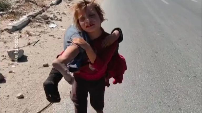 Displaced little girl carries injured sister for more than two kilometres in Gaza