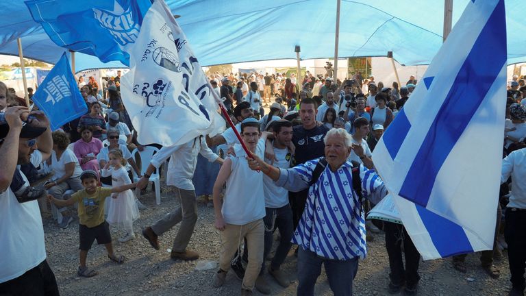 Israelis waves flags a conference is held on the resettlement of Gaza