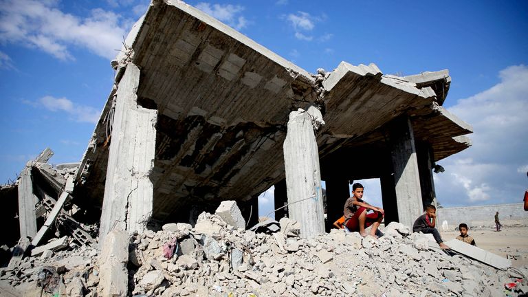 A Palestinian boys sit on piles of debris at the site of Israeli strikes on houses, amid the Israel-Hamas conflict, in Khan Younis in the southern Gaza Strip, October 2, 2024. REUTERS/Hatem Khaled