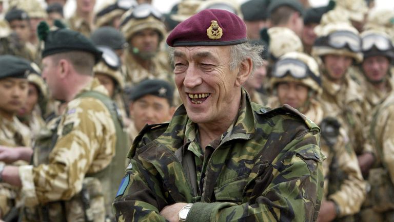 Chief of staff of the British armed forces General Sir Mike Jackson (C) smiles during his visit to the 1st Battalion Royal Irish Regiment in the Kuwaiti desert near Iraq's border on March 7, 2003. [Unidentified people have cut down part of a fence marking the demilitarized Iraq Kuwait border zone (DMZ), U.N. observers said on Friday, in a move analysts described as a preparation for possible hostilities with Iraq.]
