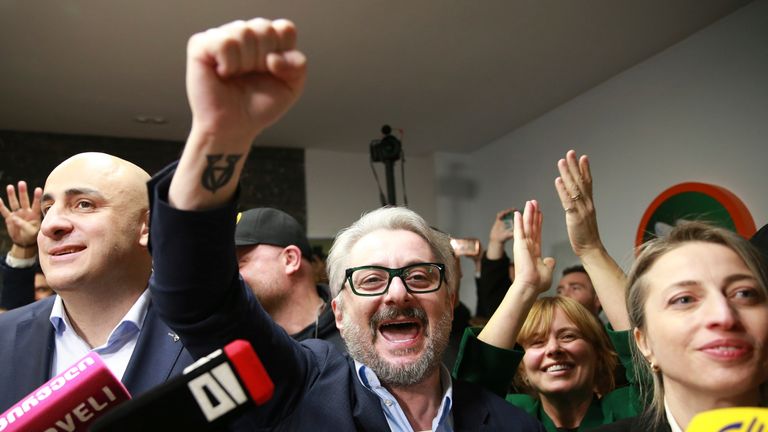 From left, Nika Melia and Nika Gvaramia, leaders of Coalition for Changes, and Nana Malashkhia, who leads the Coalition for Change parliament list, react while talking to journalists at coalition's headquarters after polls closing at the parliamentary election in Tbilisi, Georgia, Saturday, Oct. 26, 2024. (AP Photo/Zurab Tsertsvadze)