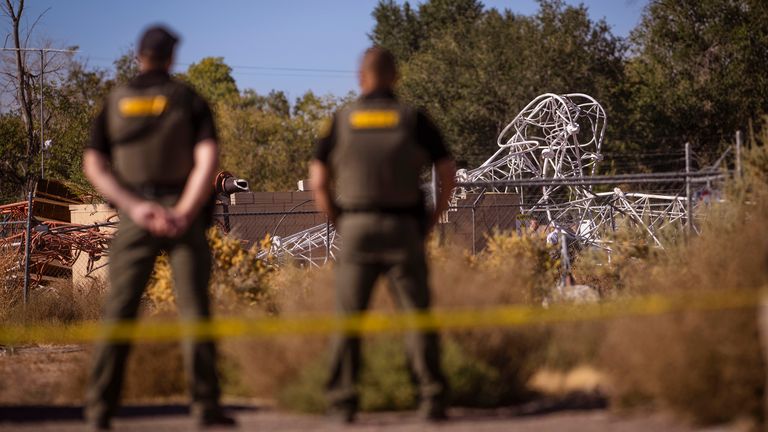 Bernalillo County Sheriff's Office personnel at the scene after a hot air balloon hit a radio tower and knocked it over near Second NW in Albuquerque, N.M., on Friday, Oct. 11, 2024. (Chancey Bush/The Albuquerque Journal via AP)