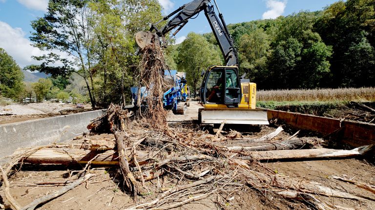 One of the few disaster response companies working in the mountain clears debris from a badly damaged bridge in the aftermath of Hurricane Helene, in Barnardsville, North Carolina, U.S. October 2, 2024.  REUTERS/Jonathan Drake