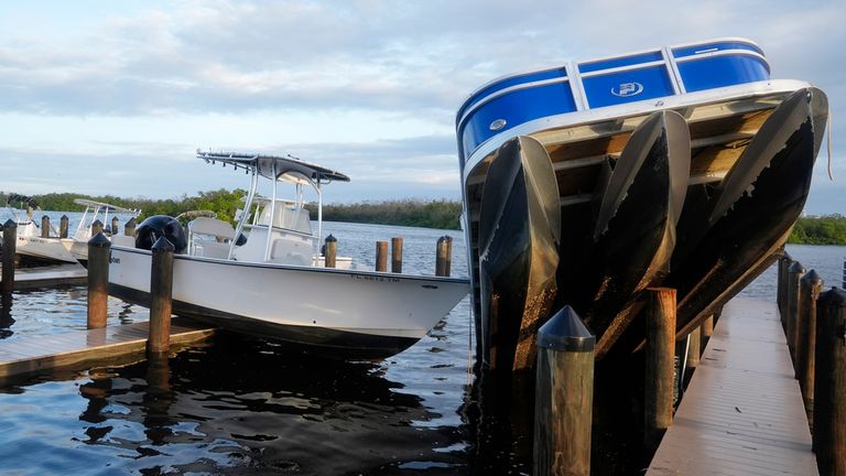 Small boats lie on a pier after being cast off during Hurricane Milton