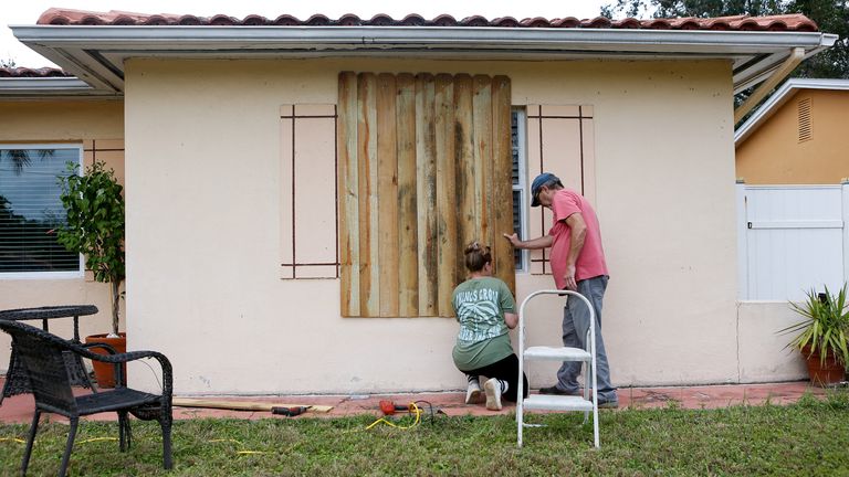 Sofia Andreeva and her uncle Ivaylo Kanchev board up their home in St Petersburg, Florida. Pic: Reuters