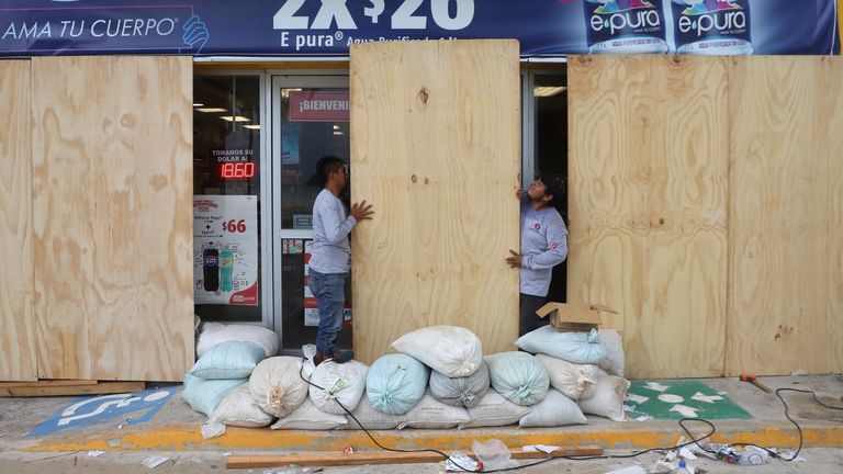 Workers board up a grocery store to protect it from Hurricane Milton, in Progreso, Mexico. Pic: AP