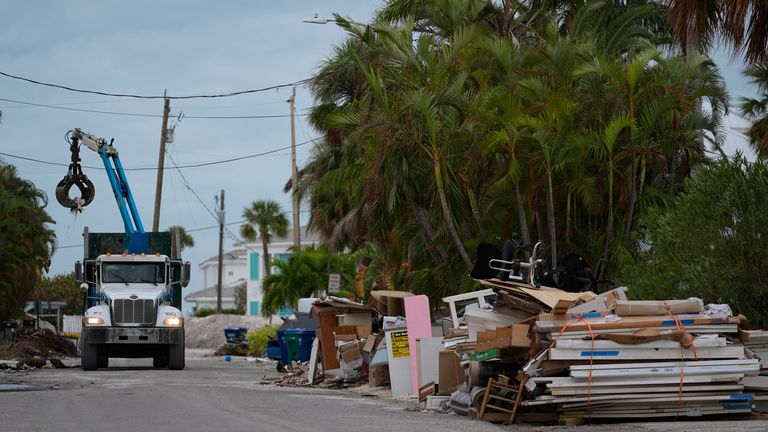 Residents are in a race against time to clear up debris from Hurricane Helene, which officials warned could be turned into projectiles by Hurricane Milton. Pic: AP