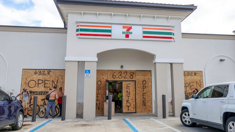 A boarded-up store remains open for now ahead of Hurricane Milton. Pic: AP