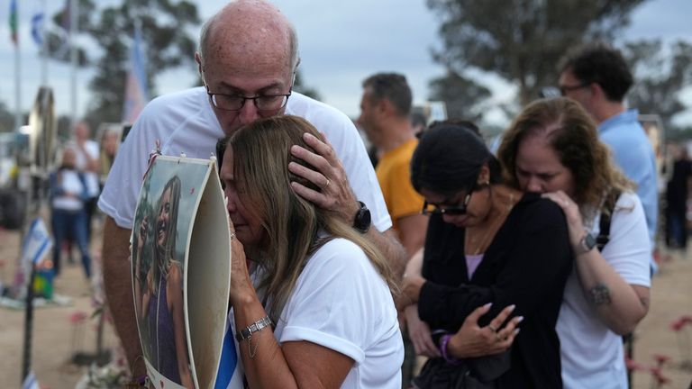 People visit the site of the Nova music festival, where hundreds of revelers were killed and abducted by Hamas and taken into Gaza, on the one-year anniversary of the attack, near Kibbutz Reim, southern Israel, Monday, Oct. 7, 2024. (AP Photo/Ariel Shalit)