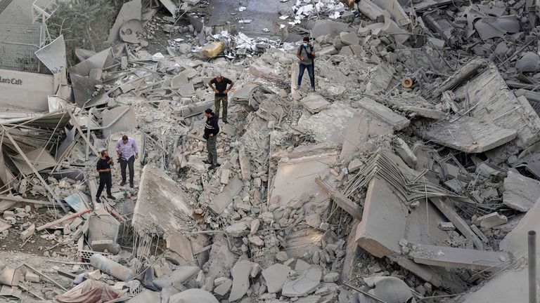 People check the site of an Israeli strike in Beirut on Wednesday. Pic: AP