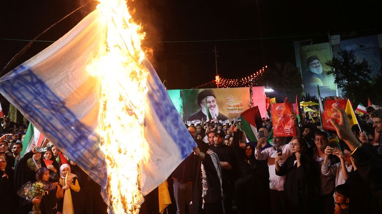 Iranians burn an Israeli flag during a celebration after the IRGC attack on Israel, in Tehran, Iran, October 1, 2024. Majid Asgaripour/WANA (West Asia News Agency) via REUTERS ATTENTION EDITORS - THIS IMAGE HAS BEEN SUPPLIED BY A THIRD PARTY ATTENTION EDITORS - THIS PICTURE WAS PROVIDED BY A THIRD PARTY