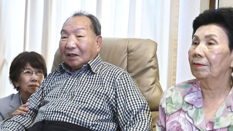 Iwao Hakamada, center, former Japanese death-row inmate acquitted after nearly 50 years on death row, and his sister Hideko, right, receive an apology from Shizuoka Prefectural Police chief Takayoshi Tsuda, not in photo, for his suffering at Hakamada's home in Hamamatsu, Shizuoka prefecture, central Japan, Monday, Oct. 21, 2024. (Kyodo News via AP)