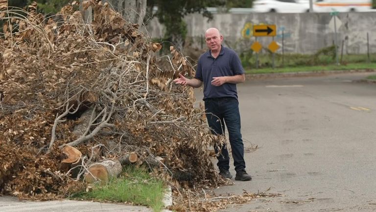 James Matthews stands next to damage from Hurricane Helene in Florida