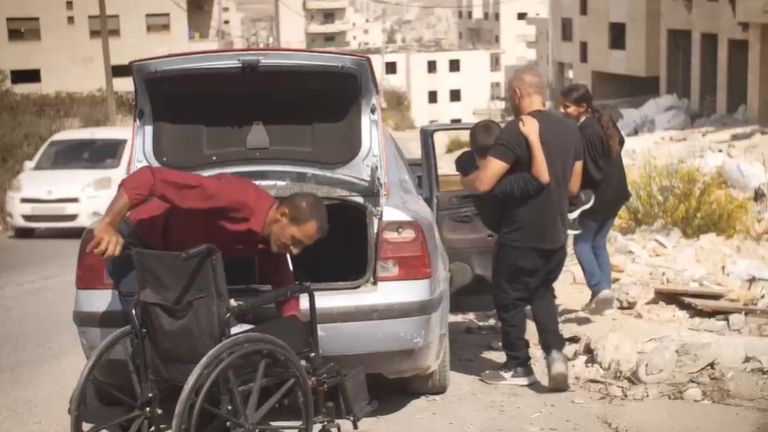 Kareem Sharaab after being taken to physio. Carried by his father Shadi, and grandfather, Hani with wheelchair. Pic: family handout