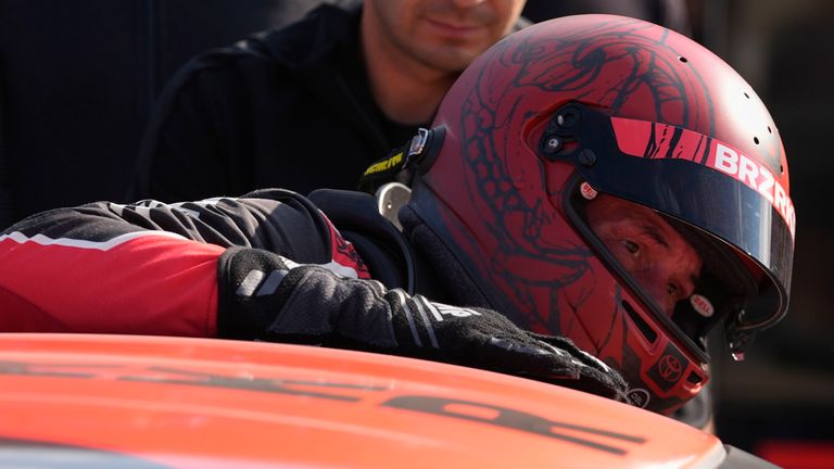 Keanu Reeves climbs out of his car following a GR Cup Series auto race at Indianapolis Motor Speedway, Saturday, Oct. 5, 2024, in Indianapolis. (AP Photo/Darron Cummings)