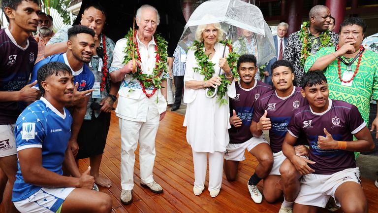 King Charles and Queen Camilla pose with local rugby players during their visit to the Samoa Cultural Village. Photo: Reuters