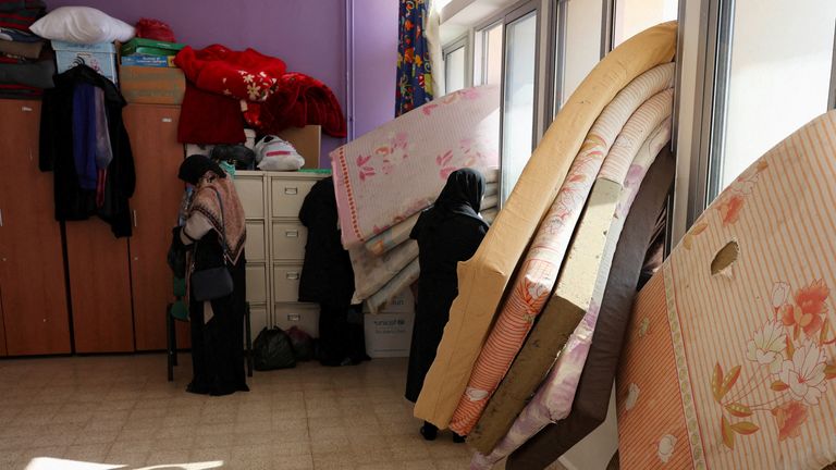 Women stand near mattresses placed on the windows of a school turned into a shelter housing displaced people who fled from Baalbek and surrounding areas, in Deir Al-Ahmar, amid ongoing hostilities between Hezbollah and Israeli forces, Lebanon October 31, 2024. REUTERS/Mohamed Azakir TPX IMAGES OF THE DAY