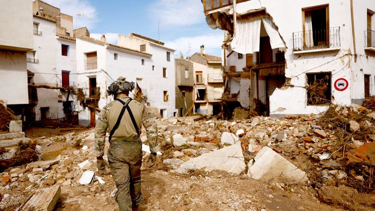 A member of Spanish UME military unit walks on the debris after heavy rains caused flooding, in Letur.
Pic: Reuters