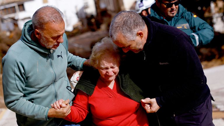 Encarna Rivero, 88, reacts as she is welcomed by her son and nephew after being stranded at a neighbours home, in Letur.
Pic: PA