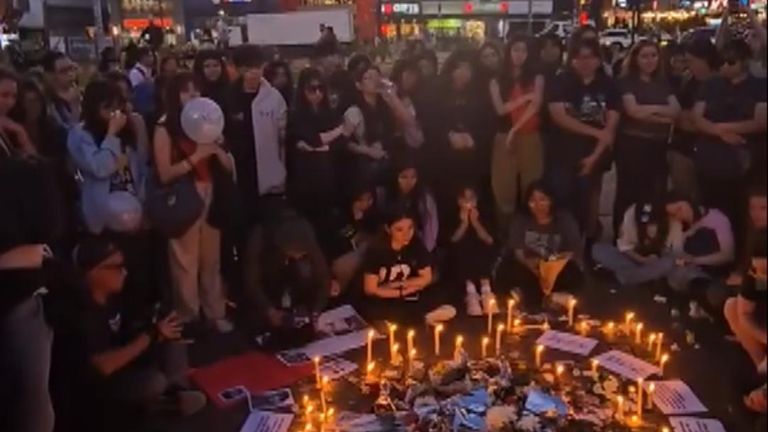 Fans sing One Direction around a candle-lit tribute for Liam Payne 