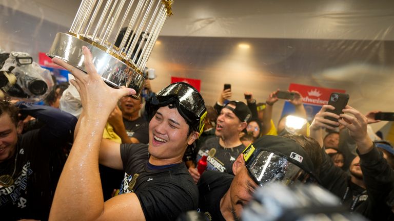 Los Angeles Dodgers' Shohei Ohtani celebrates in the locker room after their win against the New York Yankees in Game 5 to win the baseball World Series, Thursday, Oct. 31, 2024, in New York. (AP Photo/Ashley Landis)