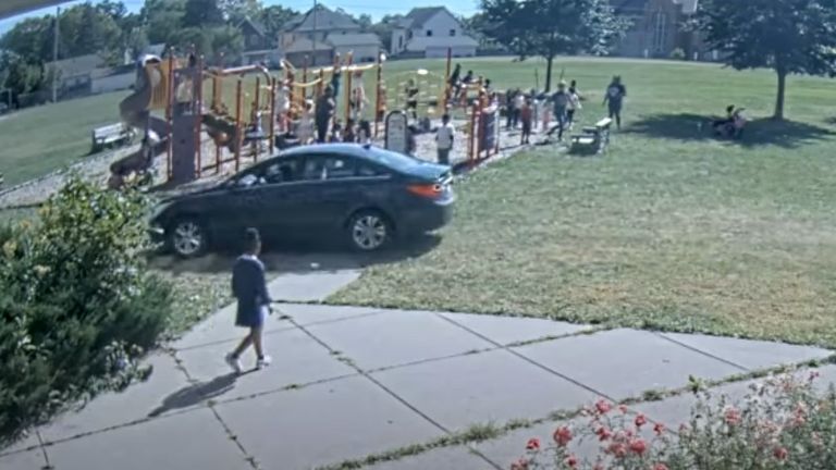 One child watched as the car passed between her and the playground. Pic: Minneapolis Police