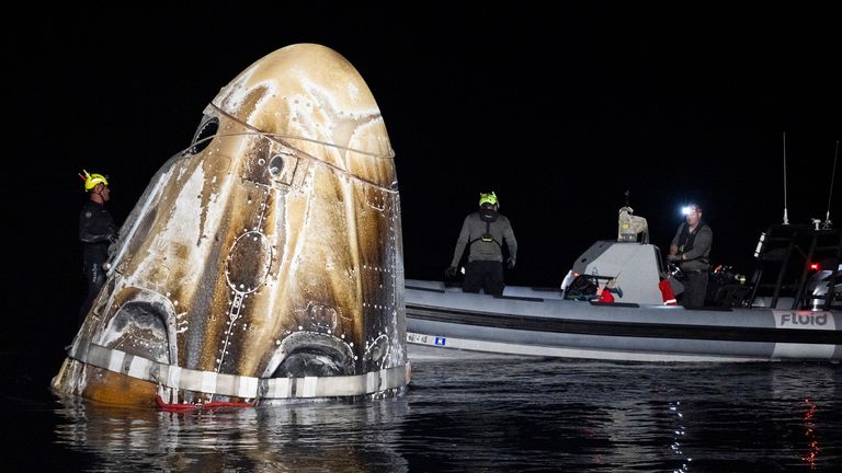 Support teams with the SpaceX Dragon Endeavour spacecraft shortly after it landed in the Gulf of Mexico off the coast of Florida. Pic: NASA via AP