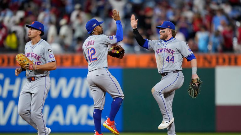 New York Mets' Harrison Bader (44), Francisco Lindor (12), and Tyrone Taylor celebrate after winning Game 1 of a baseball NL Division Series against the Philadelphia Phillies, Saturday, Oct. 5, 2024, in Philadelphia. (AP Photo/Matt Slocum)