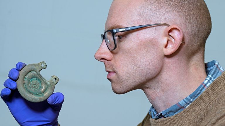 Curator Dr Matthew Knight examining a bronze object from the Peebles Hoard. Pic: Neil Hanna