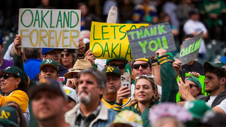 Oakland Athletics fans hold signs and chant in the stands after the Athletics' 6-4 loss to the Seattle Mariners in a baseball game Sunday, Sept. 29, 2024, in Seattle. (AP Photo/Lindsey Wasson)