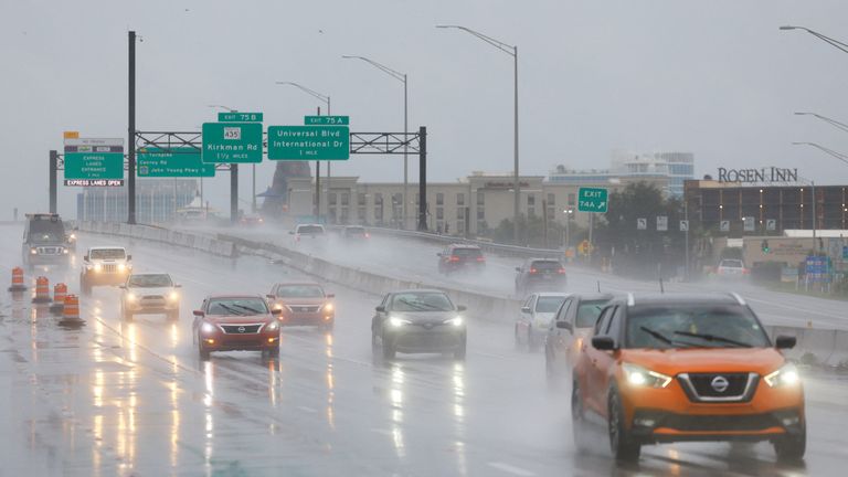 Cars drive during heavy rainfall as Hurricane Milton makes landfall in Orlando.
Pic: Reuters