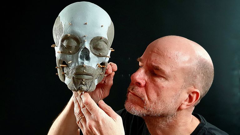 Oscar Nilsson, a Swedish archaeologist and facial reconstruction expert, poses with a three-dimensional facial skeleton in Stockholm, Sweden, in this undated handout photo. Oscar Nilsson - Project Pien/Handout via REUTERS