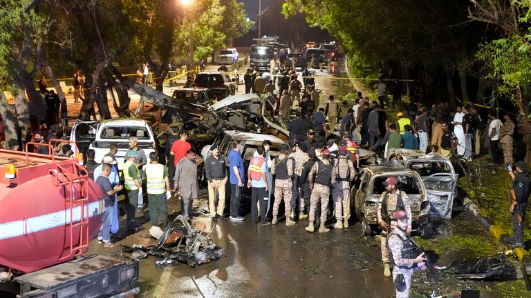 Security officials examine the site of an explosion that caused injures and destroyed vehicles at outside the Karachi airport, Pakistan, Monday, Oct. 7, 2024. (AP Photo/Fareed Khan)