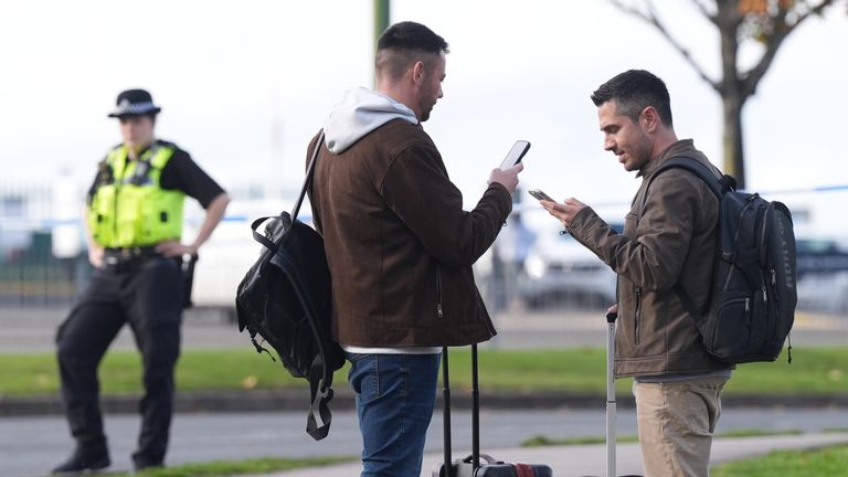 Passengers wait to board Birmingham Airport after it was evacuated following a security alert. Photo: PA