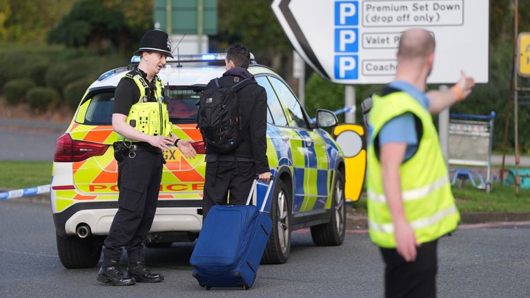 Passengers wait to board Birmingham Airport after it was evacuated following a security alert. Photo: PA