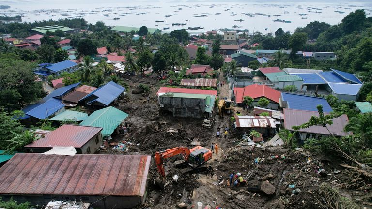 Rescuers search for bodies in Talisay, Batangas province. Pic: AP Photo/Aaron Favila