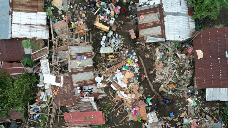 Residents gather what they can from their damaged homes on Saturday, Oct. 26, 2024 after being struck by a landslide triggered by Tropical Storm Trami in Talisay, Batangas province, Philippines. (AP Photo/Aaron Favila)