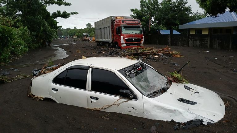 A car submerged in mud. Pic: Reuters