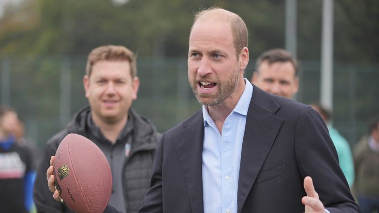 The Prince of Wales plays with an American football while speaking at a NFL Foundation Flag event.
Pic: AP